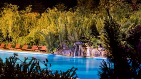 Night pool with waterfall